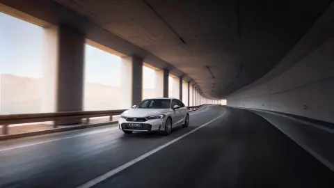 Civic Hybrid car driving through a street location.