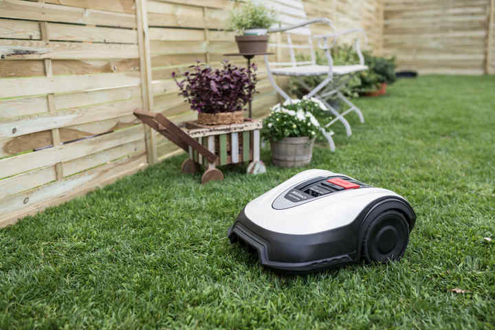 Vista ravvicinata di Honda Miimo in un giardino con mobili sullo sfondo.