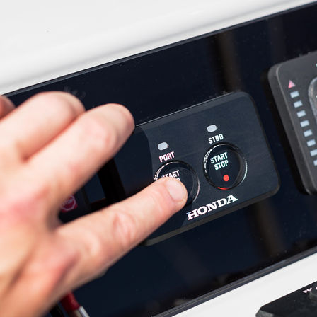 Close up of Honda marine engines start stop buttons.