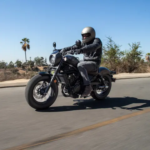 Honda CMX500 Rebel con pilota uomo in un contesto stradale. 